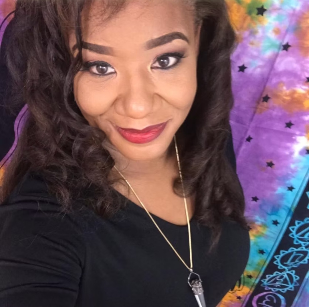 Ericka Boussarhane portrait with a chakra tapestry backdrop